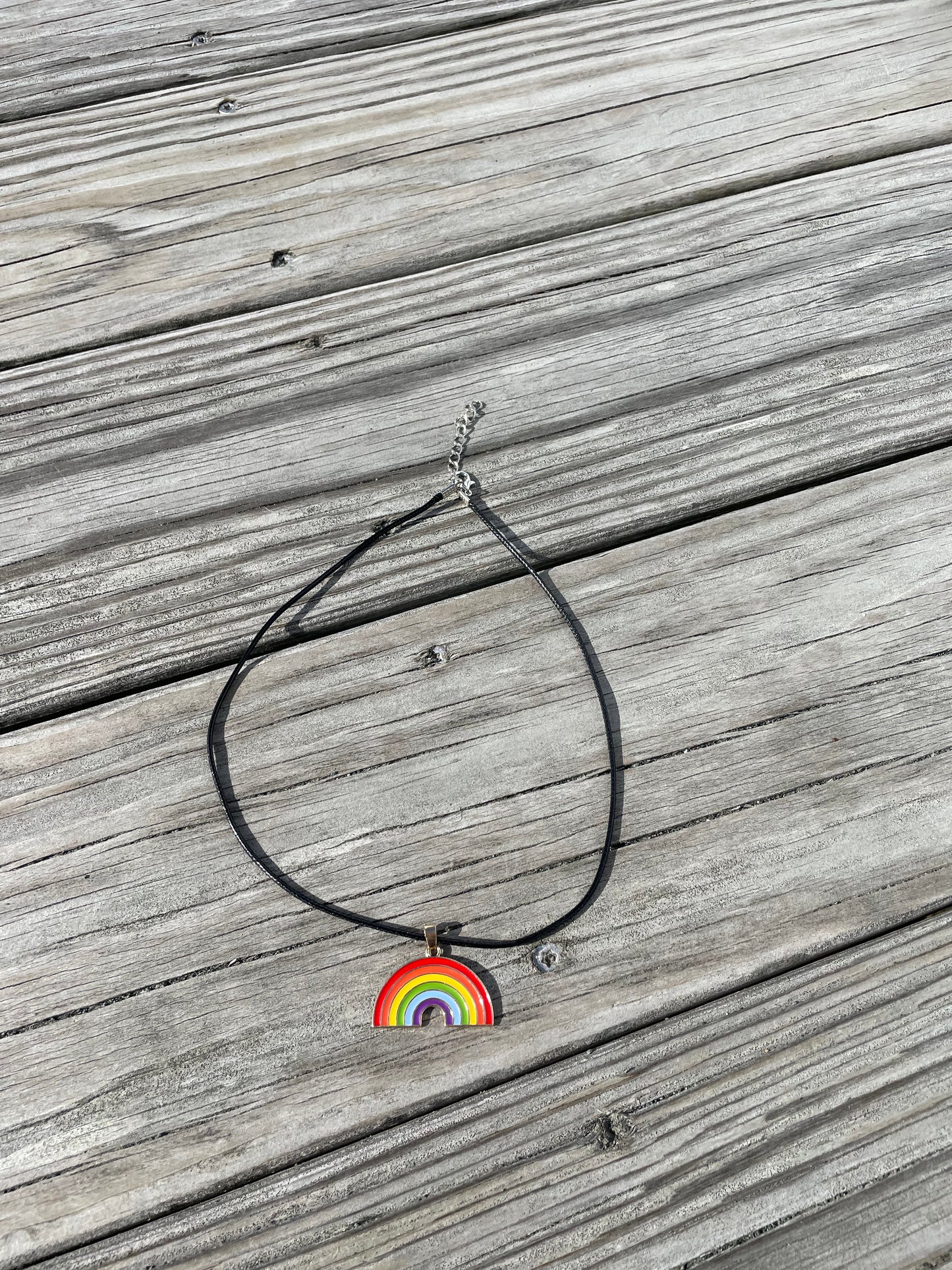 Full rainbow necklace showing adjustable cord laid out on deck