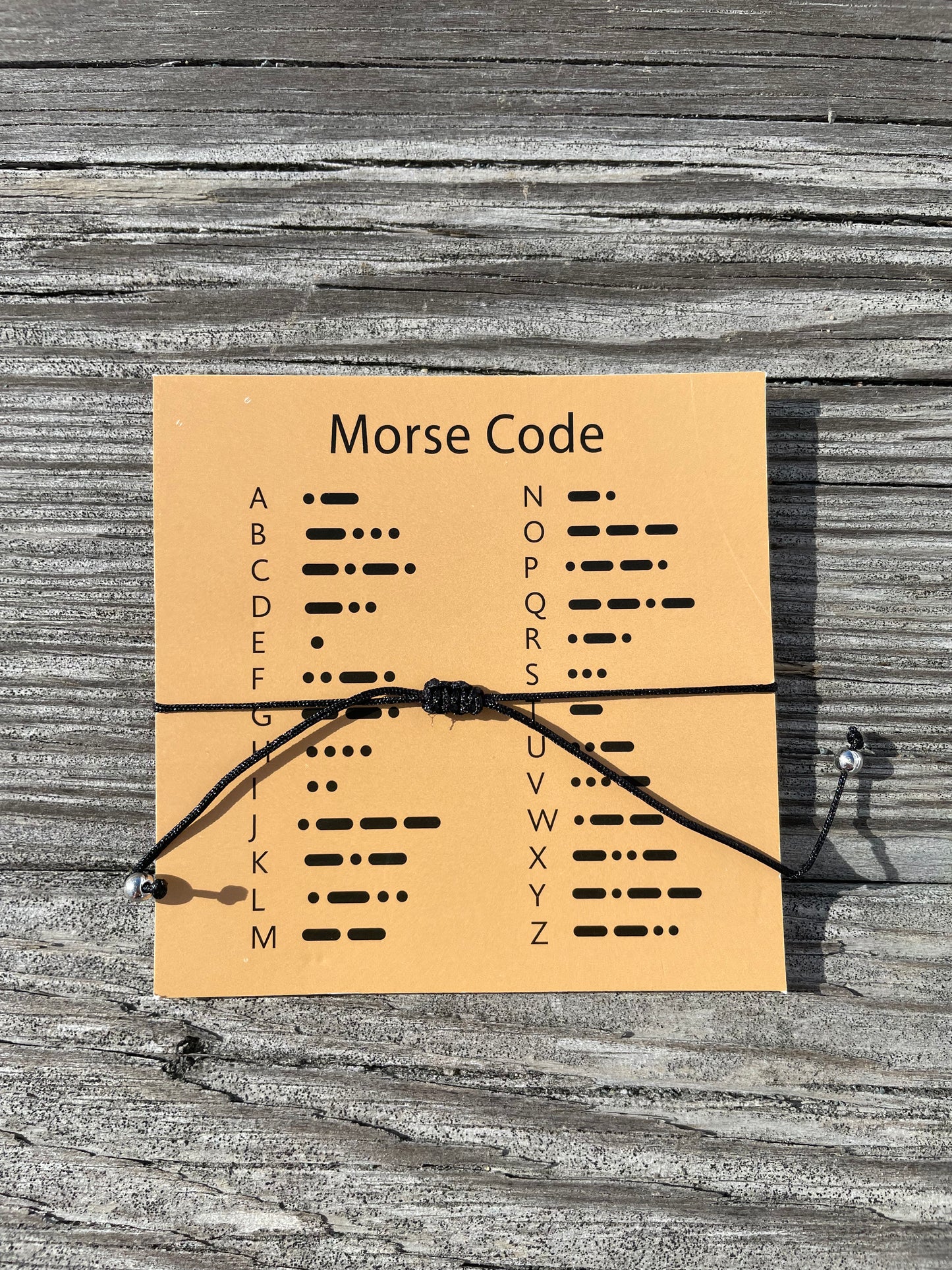 Back of card with morse code dot meanings for alphabet from A-Z