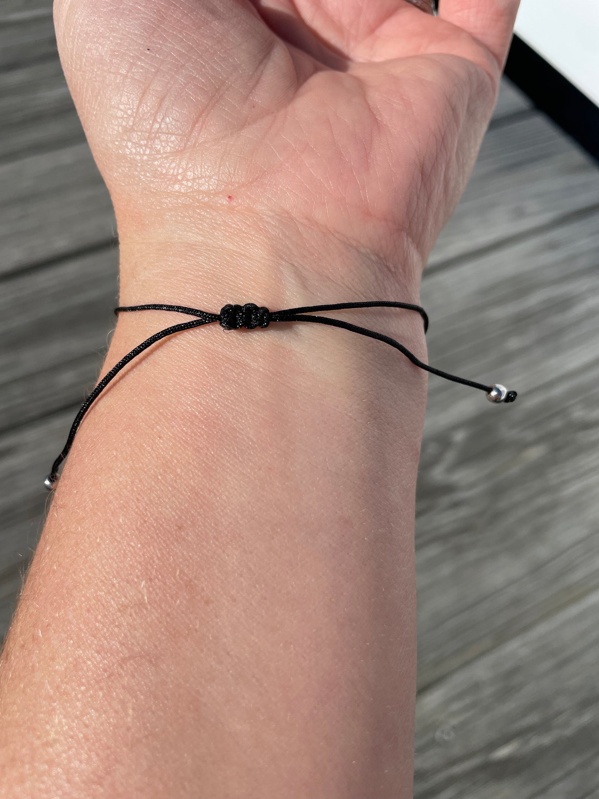 wrist wearing bracelet showing the adjustable knot