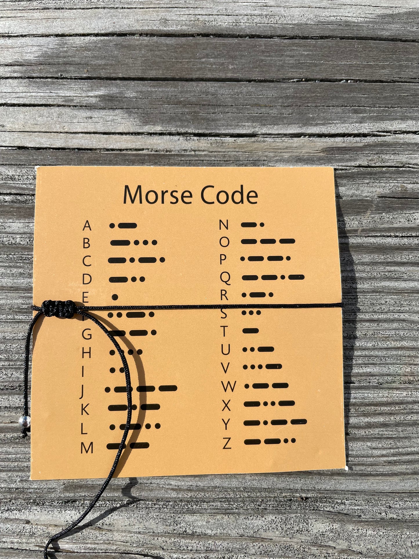 The back of the morse code card showing what each letter dot is of the alphabet