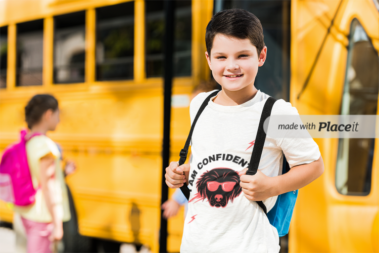Child in front of bus with I am confident shirt on